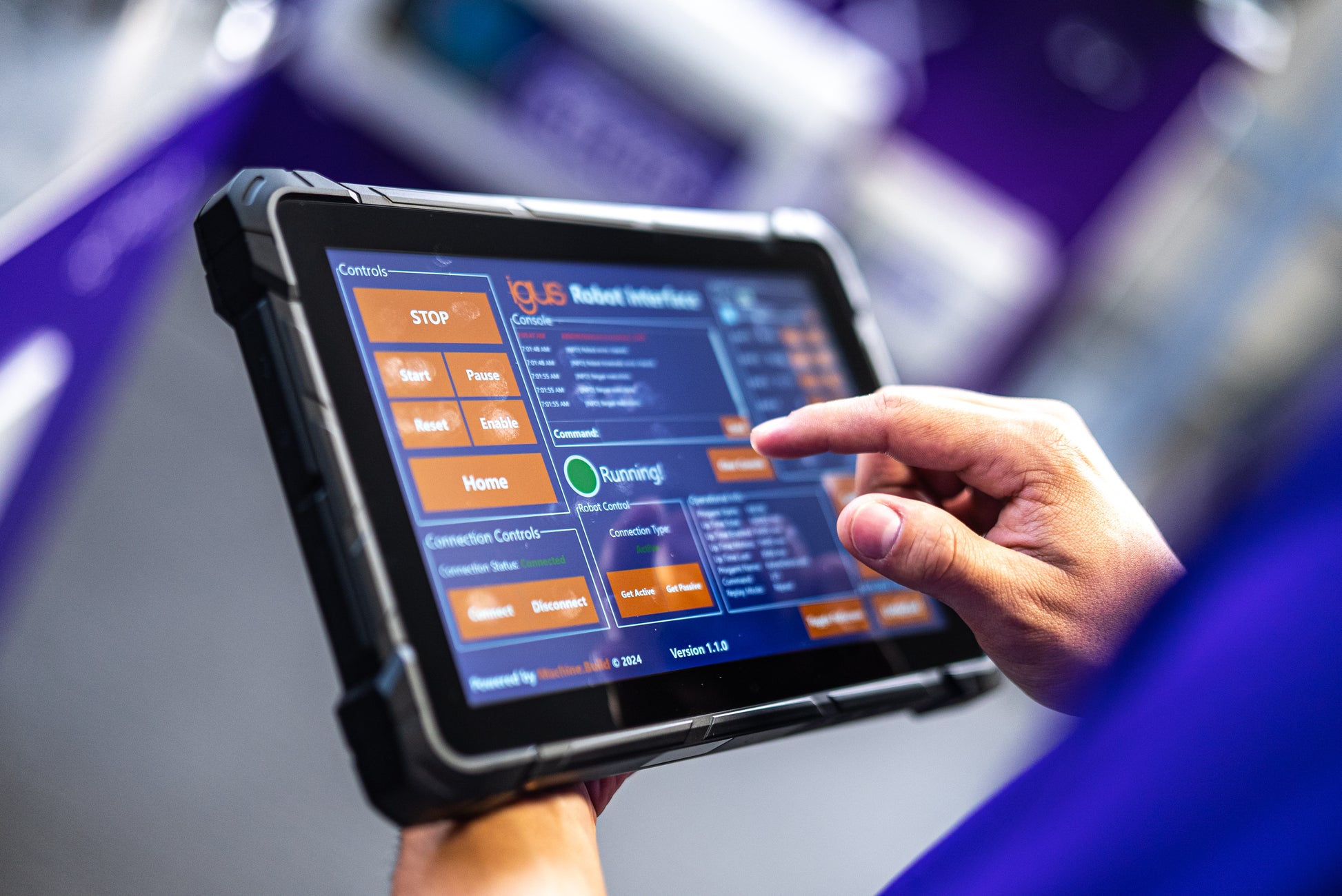 Automation specialist using HMI dashboard to monitor real-time robot status and controls.
